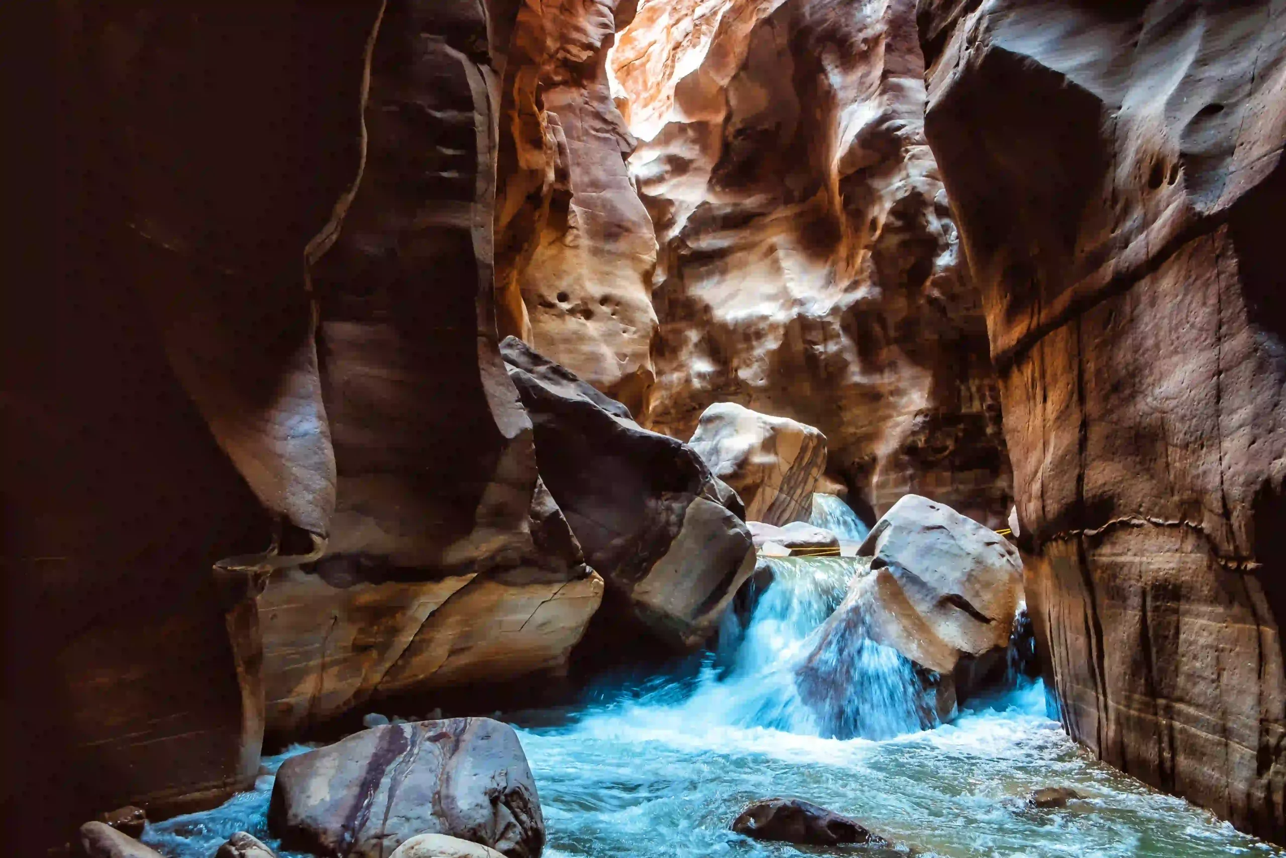 Group canyoning through Wadi Mujib gorge with waterfall